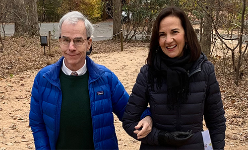 Mickey and Deirdre Daly holding hands during a walk outside