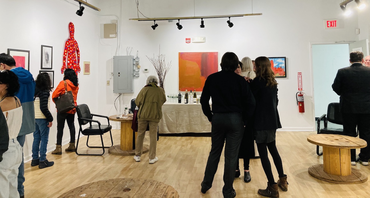 People talking and watching paintings