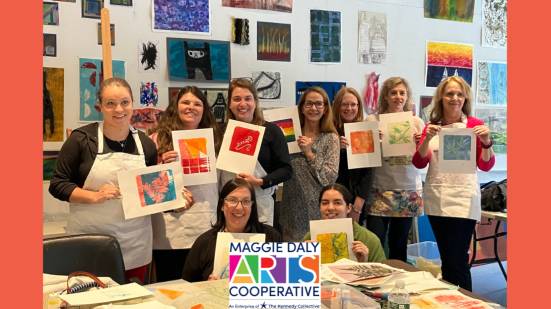 Group of women holding up paintings with "Maggie Daly Arts Cooperative" logo